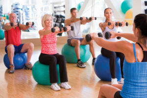 Instructor Taking Exercise Class At Gym